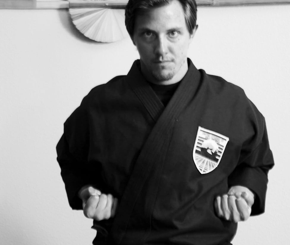 Instructor in a black martial arts uniform demonstrating a ready stance at USSD Santa Barbara.